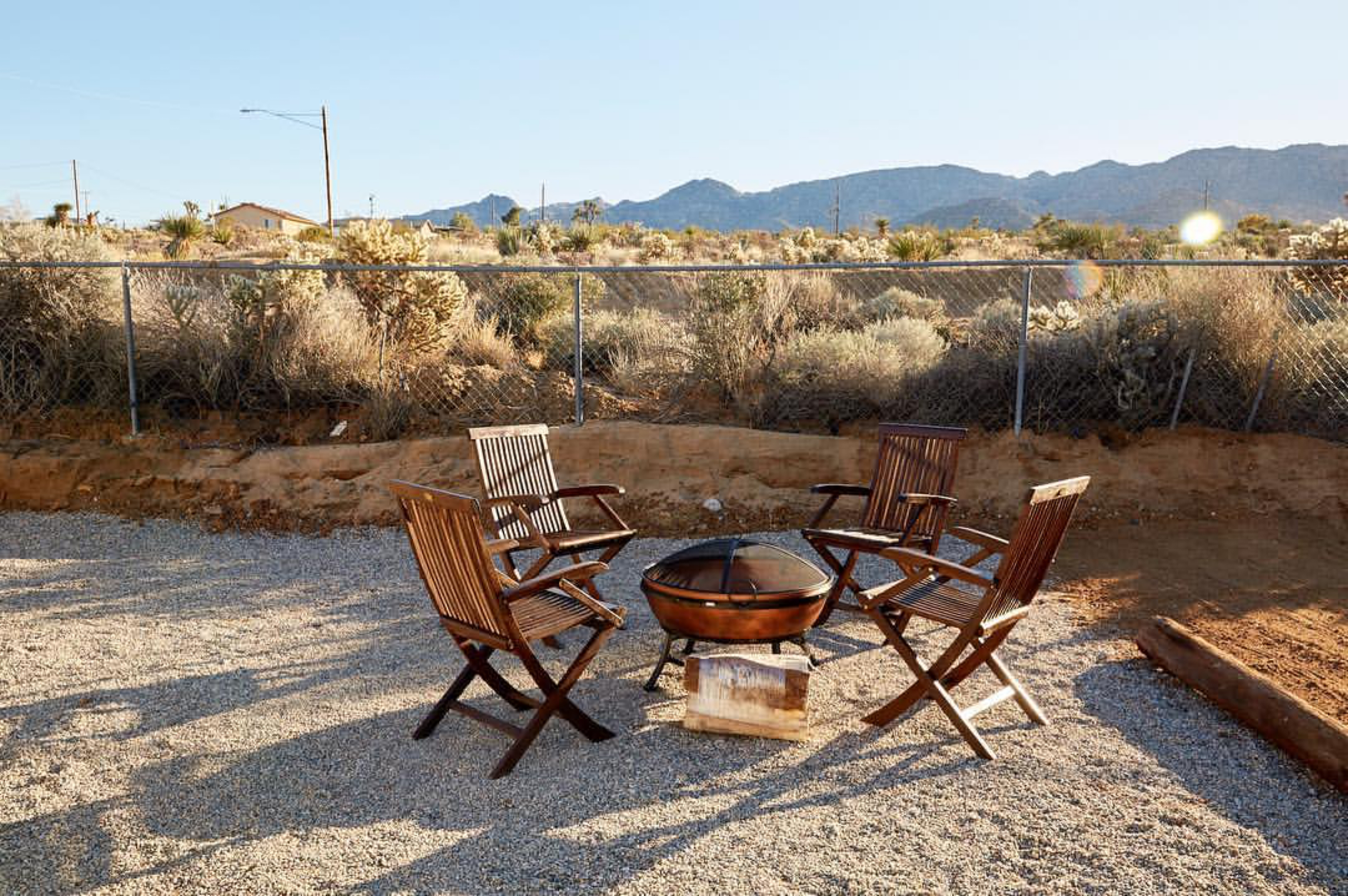Four chairs around an outdoor fire pit