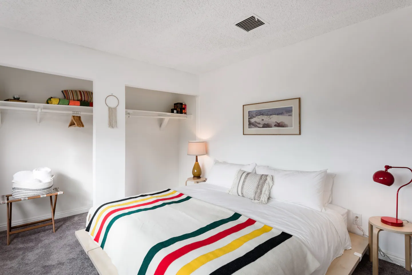 King bed with striped blanket